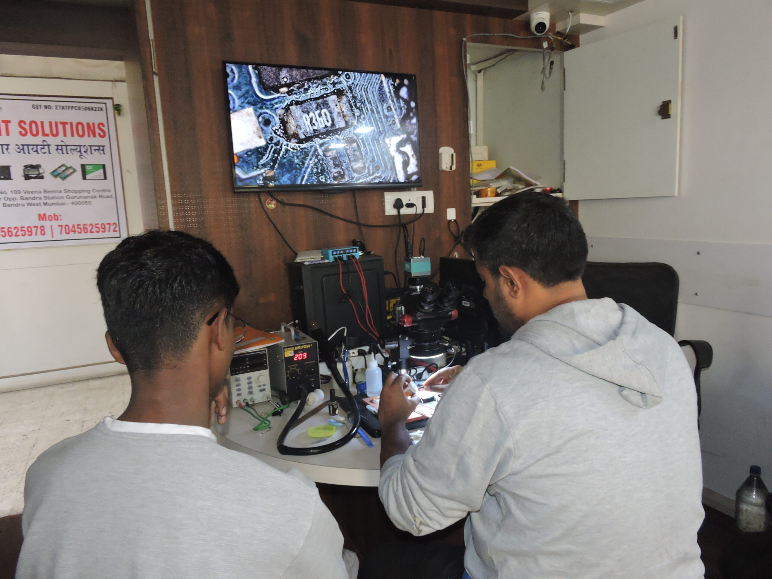 Trainer Demonstrating Mobile Board Component Replacementcomponent replacement during hands-on training.